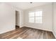 Bright bedroom with wood-look flooring and closet, offers a serene and modern aesthetic at 1534 Norman Xing, Atlanta, GA 30349