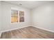 Bright bedroom features wood-look floors, neutral walls, and a window view at 1534 Norman Xing, Atlanta, GA 30349