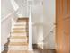 Bright entryway showcasing hardwood stairs, white walls, and modern fixtures, leading to the home's interior at 1534 Norman Xing, Atlanta, GA 30349
