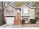 Charming two-story home featuring a well-maintained lawn, neutral siding, and classic shutters at 1534 Norman Xing, Atlanta, GA 30349