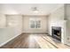 Bright living area features hardwood floors, a cozy fireplace, and large windows at 1534 Norman Xing, Atlanta, GA 30349