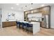 Modern kitchen with a large center island, wood and white cabinetry, stainless steel appliances, and hardwood flooring at 1610 Niskey Lake Sw Rd, Atlanta, GA 30331