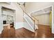 Beautiful foyer with hardwood floors and a staircase with white risers and wood railing at 1790 Aurelia Dr, Cumming, GA 30041