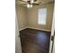 Comfortable bedroom with ceiling fan, light walls, and beautiful laminate wood flooring at 4233 Viewpoint Ln, Ellenwood, GA 30294