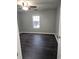 Bedroom with dark floors, gray walls, ceiling fan and natural light from the window at 4233 Viewpoint Ln, Ellenwood, GA 30294