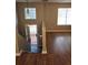 Open-concept entryway featuring laminate wood floor, a staircase, and a large window at 4233 Viewpoint Ln, Ellenwood, GA 30294