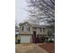 Charming two-story home with vinyl siding, a small front yard, and a one-car garage at 4233 Viewpoint Ln, Ellenwood, GA 30294