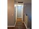 Well lit hallway with laminate wood flooring and neutral colored paint at 4233 Viewpoint Ln, Ellenwood, GA 30294