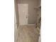 Bright laundry room with tile floors, white door, and wire shelving at 4233 Viewpoint Ln, Ellenwood, GA 30294