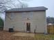 Back exterior of two story house, showing siding, backyard, and patio at 4233 Viewpoint Ln, Ellenwood, GA 30294