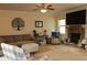 Comfortable living room boasts a fireplace, plush furniture, and ceiling fan at 149 Red Fox Dr, Dallas, GA 30157