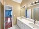 This primary bathroom features a double vanity, large mirror, and soaking tub under a window at 155 Mine Run, Fayetteville, GA 30215