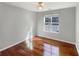 This bedroom features a large window, hardwood floors, and neutral paint at 155 Mine Run, Fayetteville, GA 30215