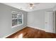 This bedroom features a large window, hardwood floors, and neutral paint at 155 Mine Run, Fayetteville, GA 30215