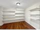 Bright bedroom featuring hardwood floors and many built-in shelves and a ceiling light at 155 Mine Run, Fayetteville, GA 30215