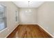 The dining room features gleaming hardwood floors and a modern chandelier at 155 Mine Run, Fayetteville, GA 30215