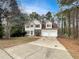 Two-story home with a two-car garage and a spacious driveway at 155 Mine Run, Fayetteville, GA 30215