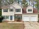 Charming two-story home with a two-car garage, landscaped yard, and welcoming front entrance at 155 Mine Run, Fayetteville, GA 30215