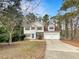 Charming two-story home featuring a well-manicured lawn and a two-car garage at 155 Mine Run, Fayetteville, GA 30215