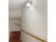 Hallway features hardwood flooring, a wooden railing, and a sconce light at 155 Mine Run, Fayetteville, GA 30215