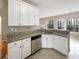 White kitchen cabinets, stainless steel appliances and granite countertops offer a timeless appeal at 155 Mine Run, Fayetteville, GA 30215