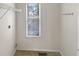 Bright laundry room features a wire rack, a window, and a neutral wall color at 155 Mine Run, Fayetteville, GA 30215