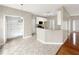 Open-concept living room with tile floor and eat-in breakfast bar at 155 Mine Run, Fayetteville, GA 30215