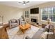 Cozy living room with a fireplace, two chairs, a sofa, and large windows at 155 Mine Run, Fayetteville, GA 30215
