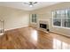 Empty living room showing fireplace, hardwood floor, and large windows at 155 Mine Run, Fayetteville, GA 30215