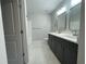 Bathroom with dual sink vanity, shower, and tile floors presents a clean and contemporary design at 229 Evergreen Trl # D, Cartersville, GA 30121