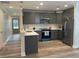 Modern kitchen with stainless steel appliances, quartz countertops, and gray cabinets offers a functional design at 229 Evergreen Trl # D, Cartersville, GA 30121