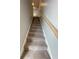 Carpeted staircase with wood railing offers a smooth transition between floors at 229 Evergreen Trl # D, Cartersville, GA 30121