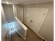 Carpeted stairway with closed closet doors and white railing at 229 Evergreen Trl # D, Cartersville, GA 30121