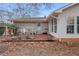 Backyard patio with brick and vinyl siding, including outdoor seating and potted plants at 3948 Bright Star Rd, Douglasville, GA 30135