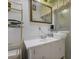 Bright bathroom featuring a vintage sink with white cabinetry, a shower, and a metal storage rack at 3948 Bright Star Rd, Douglasville, GA 30135