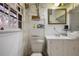Small bathroom with toilet, sink, mirror, open window, and open storage at 3948 Bright Star Rd, Douglasville, GA 30135