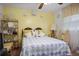 Cozy bedroom featuring a unique quilt, yellow accent wall, and decorative shelving unit at 3948 Bright Star Rd, Douglasville, GA 30135