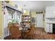 Bright dining room with rattan chairs and glass table situated near a window with decorative curtains at 3948 Bright Star Rd, Douglasville, GA 30135