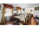 View of a dining room with table set, traditional decor, hardwood floors and bright natural light at 3948 Bright Star Rd, Douglasville, GA 30135