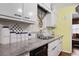 Kitchen features white cabinets, granite countertops, and open view to dining area at 3948 Bright Star Rd, Douglasville, GA 30135