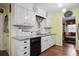 Charming kitchen features white cabinets, granite countertops, black appliances, and patterned tile backsplash at 3948 Bright Star Rd, Douglasville, GA 30135