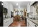 Well-lit kitchen features white cabinets, granite countertops, and a view into the dining area at 3948 Bright Star Rd, Douglasville, GA 30135