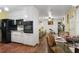 Open kitchen with white cabinets and black appliances connects to a living room with lots of natural light at 3948 Bright Star Rd, Douglasville, GA 30135
