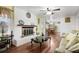 Inviting living room with a painted brick fireplace, hardwood floors, and a view into the dining area at 3948 Bright Star Rd, Douglasville, GA 30135
