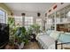Cozy sunroom featuring plant decor, ample natural light, and wood tile flooring at 3948 Bright Star Rd, Douglasville, GA 30135
