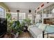Sunroom with abundant plants, natural light and tiled flooring provides great spot to relax at 3948 Bright Star Rd, Douglasville, GA 30135