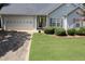 Charming home featuring manicured lawn, a two-car garage, and inviting front entrance at 142 Carl Barrett Dr, Canton, GA 30115