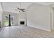 Bright living room featuring a cozy fireplace, vaulted ceilings, and sliding glass door at 142 Carl Barrett Dr, Canton, GA 30115