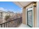 Balcony with a black metal railing showing an adjacent multi story building and mature trees at 2201 Stratford Commons, Decatur, GA 30033