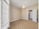 Bright bedroom with neutral walls, ceiling fan, tan carpet and a door leading to closet or bathroom at 2201 Stratford Commons, Decatur, GA 30033